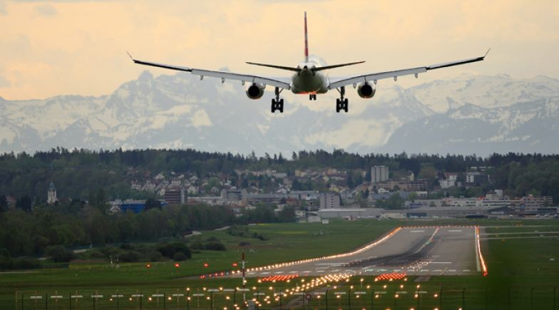 White biplane landing at airport